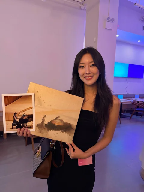 Yeaji holding artwork from ARTUE at the Chingu event at Teo Nomad