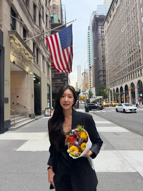 Yeaji holding flowers on a Manhattan street